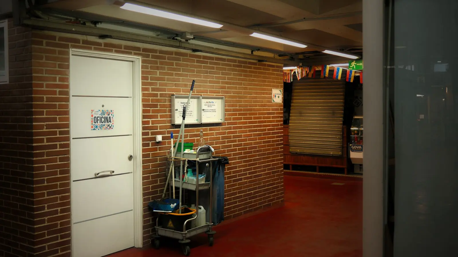 Commercial cleaning cart and supplies in a brick hallway in Bridgeport, CT